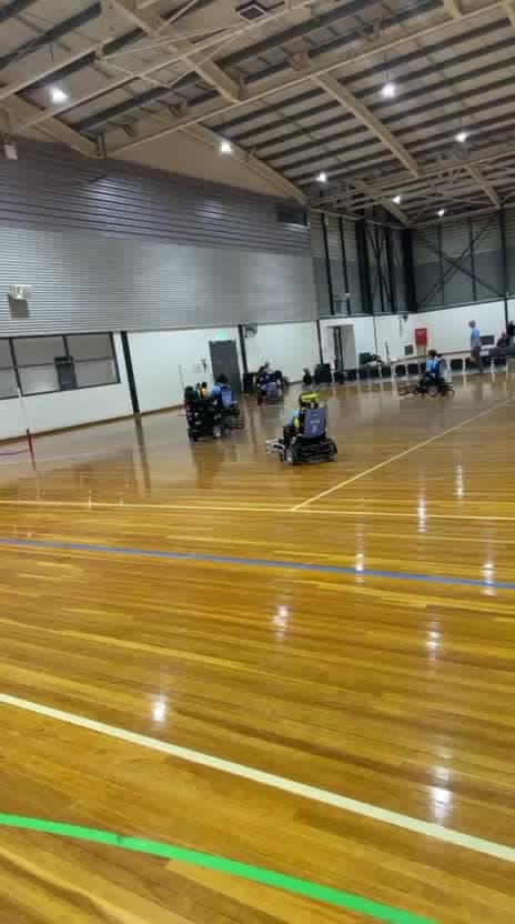 A powerchair football match in a community sports hall